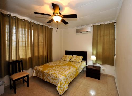 a bedroom with a bed and a ceiling fan at Totumas Lodge in Panama City