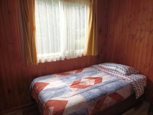 Postel nebo postele na pokoji v ubytování El Urco Chiloé - Cabaña El Caleuche