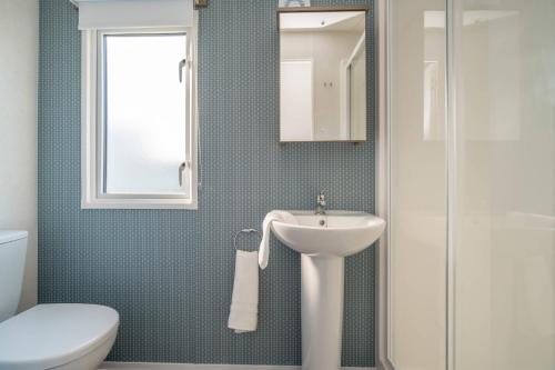 a bathroom with a sink and a toilet and a shower at Lisa Marie-Luxury Caravan-Seton Sands-8 Berth in Port Seton