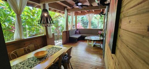 a room with a table and chairs in a house at Boutique Hotel y Spa Tangara Azul in Ojochal