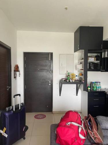 a living room with luggage and a red bag at Ranga Vila’s on ECR in Chennai