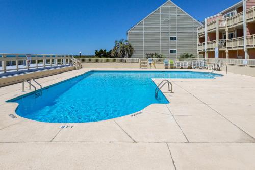 a swimming pool with blue water in a building at CAB03 Pelicans Penthouse in Oak Island