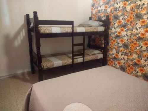 Postel nebo postele na pokoji v ubytování Casa Guacuri - Casa de temporada e eventos - apartamentos com suítes - Piscinas e Amplo Estacionamento