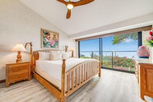 a bedroom with a bed and a large window at WAILEA ELUA, #1305^ condo in Wailea