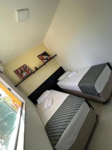 Postel nebo postele na pokoji v ubytování Hotel Flores de Holambra