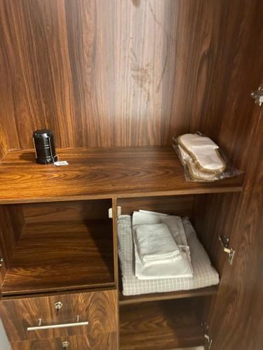 a cupboard with some towels and a phone on it at The Flora in Ahangama