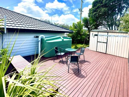 a patio with two chairs and a table on a deck at Albany Modern Private 2 bedroom 2 bathroom with Full Kitchen Netflix in Auckland