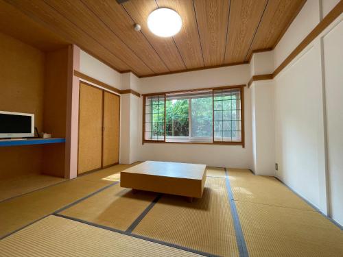 a room with a table in the middle of a room at Muikamachi Hutte in Minami Uonuma