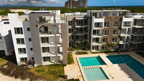 an aerial view of an apartment complex with a swimming pool at Hard Rock Punta Cana Coral Bay II apartment 2 BR by BTC Crypto Group in Punta Cana