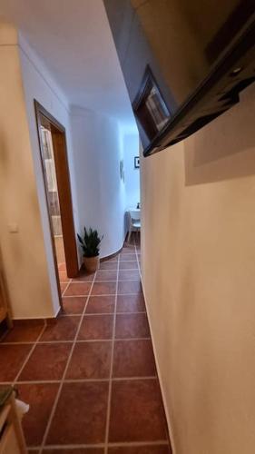 a hallway with a tile floor in a house at Cantinho da Vila by Portus Alacer in Alter do Chão