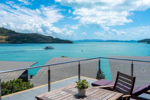 a balcony with a view of the water at Yacht Club Villas on Hamilton Island by HIHA in Hamilton Island