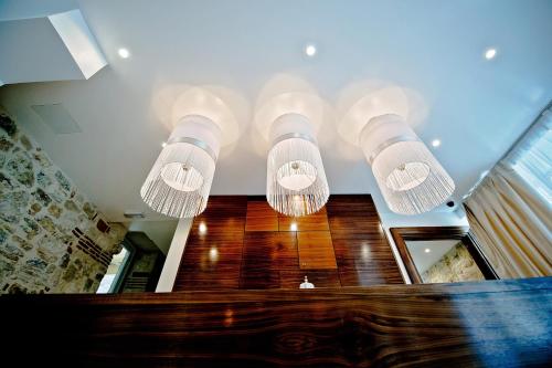 a group of lights hanging from a ceiling at Jupiter Heritage Hotel in Split