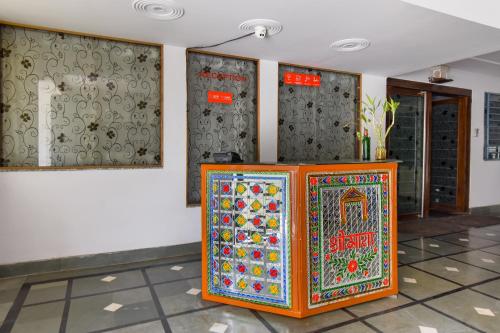 a colorful cabinet in a room with a wall at OYO Flagship Hotel Sawraj Regency in Sohāna