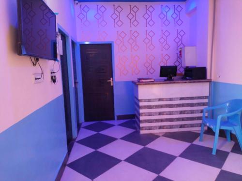 a room with a door and a checkerboard floor at OYO Blue Dream Palace in Nārnaul