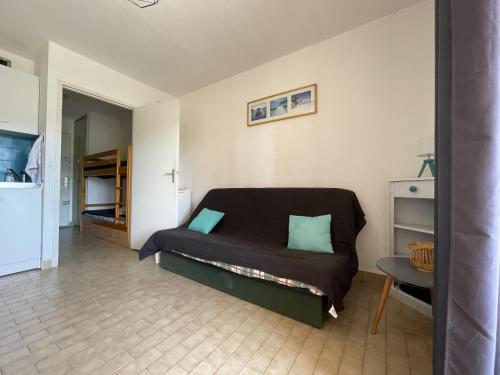 a small bedroom with a bed and a table at Studio Sète, 1 pièce, 4 personnes - FR-1-338-434 in Sète