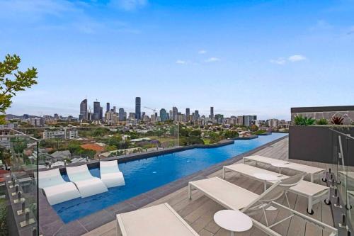 a swimming pool on the roof of a building with a city at Gabba Oasis:Luxury 3BRM Apt Pool in Brisbane