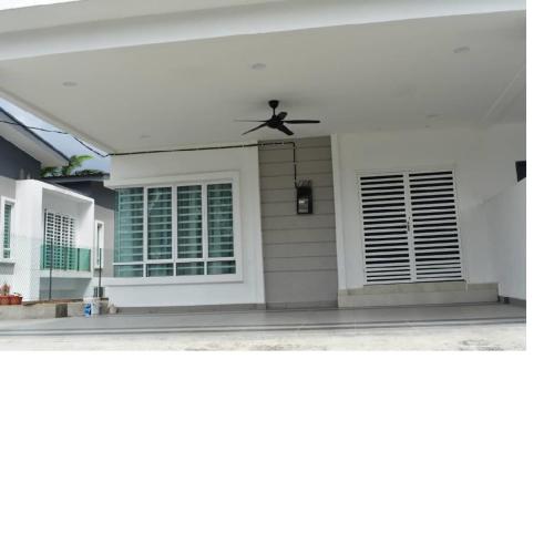 a house with a ceiling fan and two windows at Room for short stay with shared facilities in Seremban