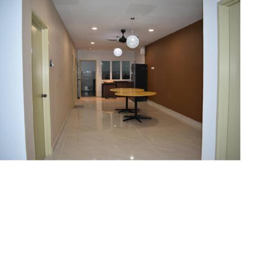 a hallway with a table and a dining room at Room for short stay with shared facilities in Seremban