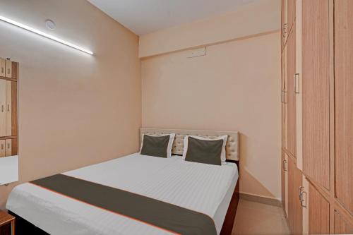 a small bedroom with a bed and a closet at Collection O Ns Service Apartment in Tirupati