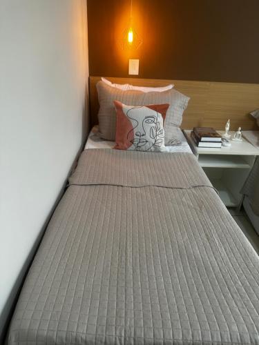a large bed in a room with a bed sidx sidx sidx at Flat B306 Village Aldeia das Águas in Barra do Piraí