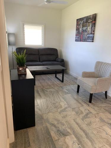 a living room with a couch and a chair at Downtown Hilo Apt L in Hilo