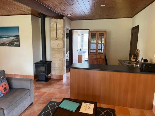 a living room with a bar and a stove at Happy Dogs Cottage Margaret River in Margaret River Town
