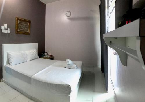Ένα ή περισσότερα κρεβάτια σε δωμάτιο στο AQIL BEACH INN