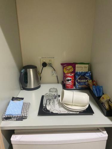 a kitchen counter with a plate and food on it at Deniliquin Country Club Motor Inn in Deniliquin