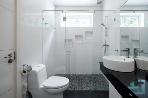 a bathroom with a toilet and a sink and a shower at Orchid Paradise Homes OPV 210 in Hua Hin
