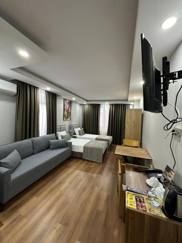 a living room with a couch and a tv at Marista Pansiyon in Istanbul