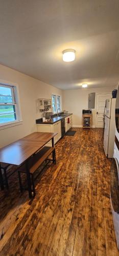 a kitchen with a wooden table and a wooden floor at Cozy Compass House in Tellico Plains