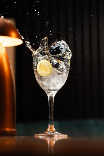 a glass of water with a lemon in it at West Hotel Sydney, Curio Collection by Hilton in Sydney