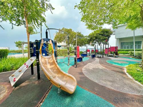 a playground with a slide in a park at Teega Residence By Stayrene in Nusajaya