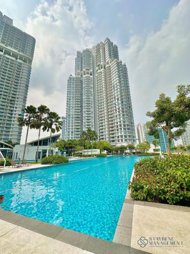 a large swimming pool in front of tall buildings at Teega Residence By Stayrene in Nusajaya