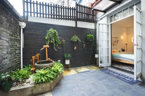 a courtyard with plants on a brick wall at Shanghai Celebrity Courtyard B&B in Shanghai