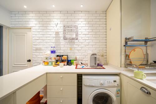 a kitchen with a washing machine on a counter at Shanghai Celebrity Courtyard B&B in Shanghai