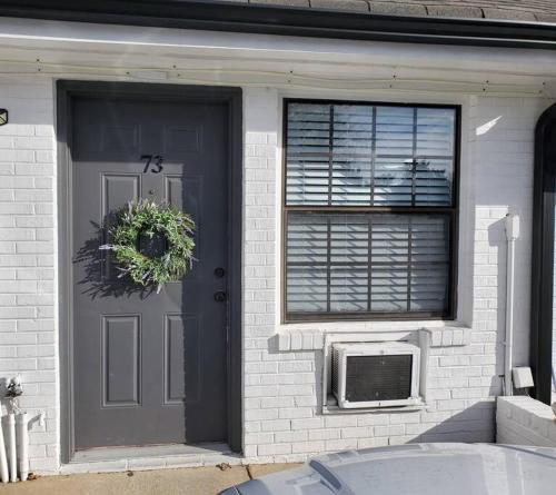 una puerta delantera de una casa con ventana y una puerta con ventilador en Cute tiny-apartment loft near NC State en Raleigh