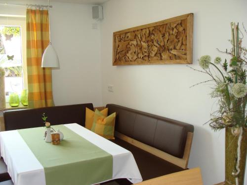 a dining room with a table and a bench at Drei Tannen in Bodenmais