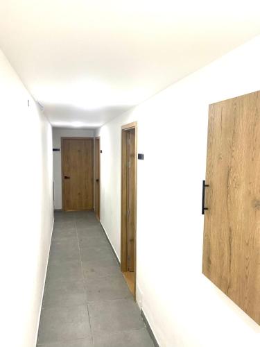 an empty hallway with two doors and a hallwayngth at Villa Estadio in Medellín