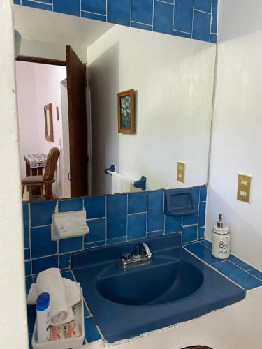 a blue tiled bathroom with a blue sink at Mesón Don Quijote in Ajijic