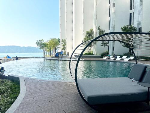 a bench sitting next to a pool in a building at The Shore Kota Kinabalu City Centre by LW Suites in Kota Kinabalu