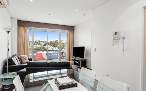 a living room with a couch and a glass table at 412, 162 Hindmarsh Rd, Victor Harbor in Victor Harbor