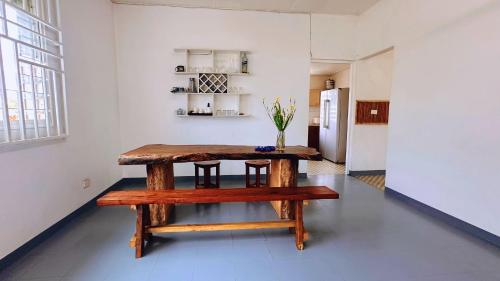 a wooden table in a room with a kitchen at Kerith Lodge in Port Vila