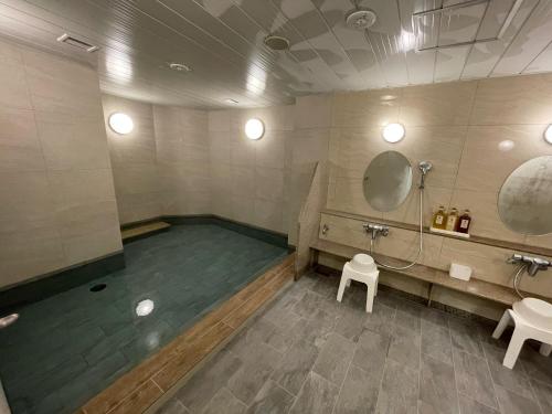 a bathroom with two sinks and a mirror at Kawasaki Hotel Park - Vacation STAY 02891v in Kawasaki