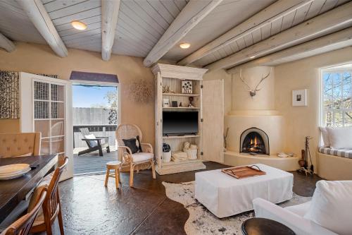 a living room with a table and a fireplace at Casa TATIZ • Privacy in a Southwestern Gem in Santa Fe