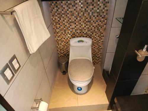 a small bathroom with a toilet in a stall at Riversuits#1 Santa Ana in Guayaquil