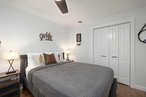 a white bedroom with a bed and a white closet at The Lofts on Indian Point - Near Silver Dollar City in Branson