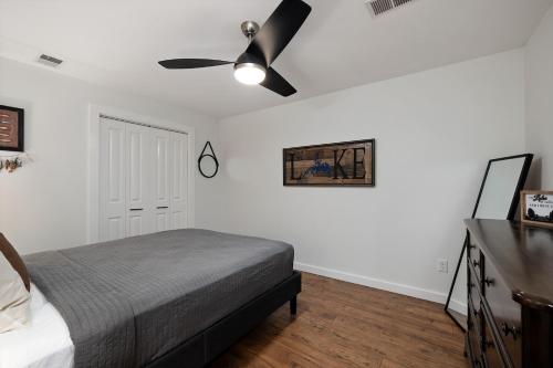a bedroom with a bed and a ceiling fan at The Lofts on Indian Point - Near Silver Dollar City in Branson