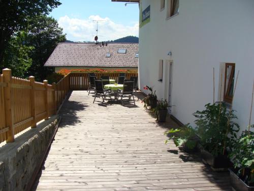 a patio with a table and chairs and a building at Drei Tannen in Bodenmais