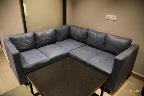 a leather couch in a living room with a coffee table at Belvedere Suites in Greater Noida